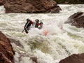 Rafting, brave and courageous people conquer water obstacles on a mountain river on rafts, along the river, in the spring.