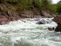 Rafting, brave and courageous people conquer water obstacles on a mountain river on rafts.