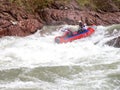 Rafting, brave and courageous people conquer water obstacles on a mountain river on rafts..