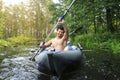 Rafting in a canoe by the river. Young guys with oars in a boat sail on the river in the summer