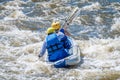 Rafting, kayaking. Two sportsmen are sailing on a rubber inflatable boat in a boiling water stream. Teamwork.