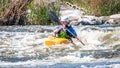 Rafting, kayaking. An unidentified man are sailing on his short Dagger whitewater kayak. Ecological water tourism.