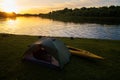 Rafting on kayaks. A tent camp stands on the river bank.