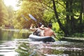 Rafting on the river in a kayak in the summer season. Leisure. Two people in the boat row with oars