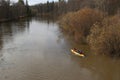 Rafting on the river. tourists swim in the forest river in the flood on a canoe. kayaking on high water in the spring forest. Royalty Free Stock Photo