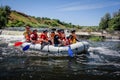 Rafting team , summer extreme water sport . Group of adventurer doing white water rafting