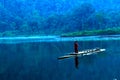 A raftsman on a blue lake