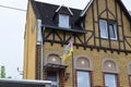 ragged German flag in front of an olf house