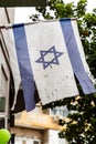 Israeli flag hanging on a building door in Tel Aviv, Israel