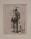 Ragged Peasant with His Hands Behind Him, Holding a Stick from 1630 by Rembrandt