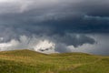 Ragged storm clouds in the sky over hills and prairie in Nebraska. Royalty Free Stock Photo