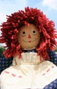 Raggedy Anne doll sitting outside, Old Time Rag Doll, Ghost mystic doll. Scary horror doll.