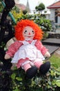 Raggedy Anne doll sitting outside, Old Time Rag Doll, Ghost mystic doll. Scary horror doll.