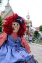 Raggedy Anne doll sitting outside, Old Time Rag Doll, Ghost mystic doll. Scary horror doll.