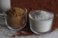 Ragi flour and raw sugar in a glass bowl along with a scattered spread of ragi grains around Royalty Free Stock Photo