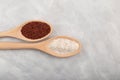 Ragi or Nachni, also known as finger millet and ragi coarse flour in wooden spoons, close-up. Top view, grey textured background Royalty Free Stock Photo