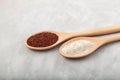 Ragi or Nachni, also known as finger millet and ragi coarse flour in wooden spoons on grey background Royalty Free Stock Photo