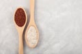 Ragi or Nachni, also known as finger millet and ragi coarse flour in wooden spoons on grey textured table. Top view, copy space Royalty Free Stock Photo