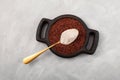 Ragi or Nachni, also known as finger millet and ragi flour in wooden plate with golden spoon, top view. Gluten free healthy food. Royalty Free Stock Photo