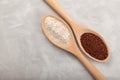 Ragi or Nachni, also known as finger millet and ragi flour in wooden spoons on grey background. Gluten free healthy food Royalty Free Stock Photo