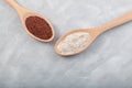 Ragi or Nachni, also known as finger millet and ragi flour in wooden spoons on grey table. Selective focus, copy space Royalty Free Stock Photo