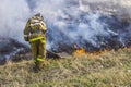 Raging forest spring fires. Burning dry grass, reed along lake. Grass is burning in meadow. Ecological catastrophy. Fire and smoke Royalty Free Stock Photo