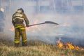 Raging forest spring fires. Burning dry grass, reed along lake. Grass is burning in meadow. Ecological catastrophy. Fire and smoke Royalty Free Stock Photo