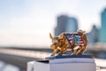 A raging golden bull souvenir on the Brooklyn Bridge in New York, USA