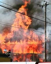 Raging House Fire with Thick Smoke Partial Firetruck in Foreground