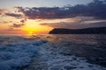 Raging sea waves at sunset in the ocean.