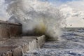 Raging waves crashing on a stone pier. Royalty Free Stock Photo