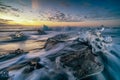 Raging waves smashing ice blocks at sunrise on Diamond Beach Royalty Free Stock Photo