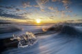 Raging waves smashing ice blocks at sunrise on Diamond Beach Royalty Free Stock Photo