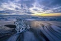 Raging waves smashing ice blocks at sunrise on Diamond Beach Royalty Free Stock Photo