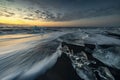 Raging waves smashing ice blocks at sunrise on Diamond Beach Royalty Free Stock Photo