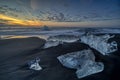 Raging waves smashing ice blocks at sunrise on Diamond Beach Royalty Free Stock Photo