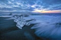 Raging waves smashing ice blocks at sunrise on Diamond Beach Royalty Free Stock Photo