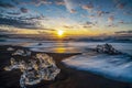 Raging waves smashing ice blocks at sunrise on Diamond Beach Royalty Free Stock Photo