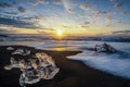 Raging waves smashing ice blocks at sunrise on Diamond Beach Royalty Free Stock Photo