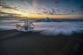 Raging waves smashing ice blocks at sunrise on Diamond Beach Royalty Free Stock Photo