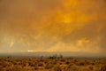 A raging wildfire rips through the Sierra Nevada mountains in California, turning the sky into a blaze of orange smoke