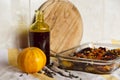 Ragout, cutting board, bottle and a pumpkin on a towel