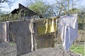 The rags are dried after washing against the background of a dilapidated house, slums and poor areas. Ãârying laundry