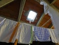 rags and tea towels hung out to dry after washing in the attic o Royalty Free Stock Photo