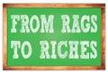 FROM RAGS TO RICHES words on green wooden frame school blackboard Royalty Free Stock Photo