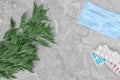 Ragweed Ambrosia with face mask and allergy medication on grey marble background, flat lay