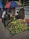 23.07.2023. Raiganj, India. An Indian vegetable seller sitting under the umbrella in a market