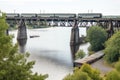 rail bridge over a river, with boats passing below