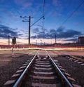 Rail crossing with blurred car lights at beautiful sunset. Railway