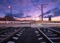 Rail crossing with blurred car lights at beautiful sunset. Railway Royalty Free Stock Photo